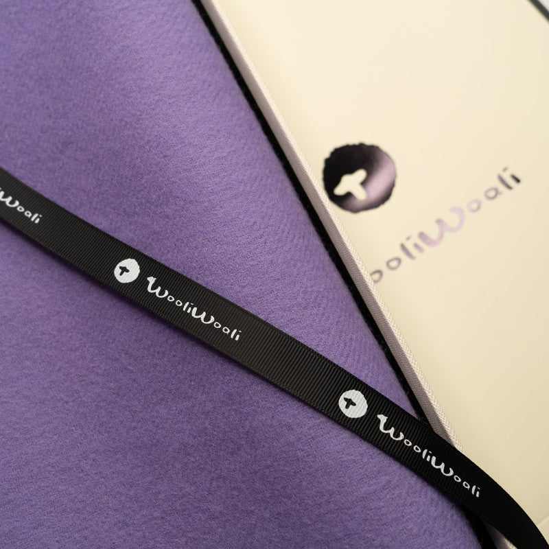 Black strap with 'WooliWooli' branding on a purple scarf (Gift Wrapped).