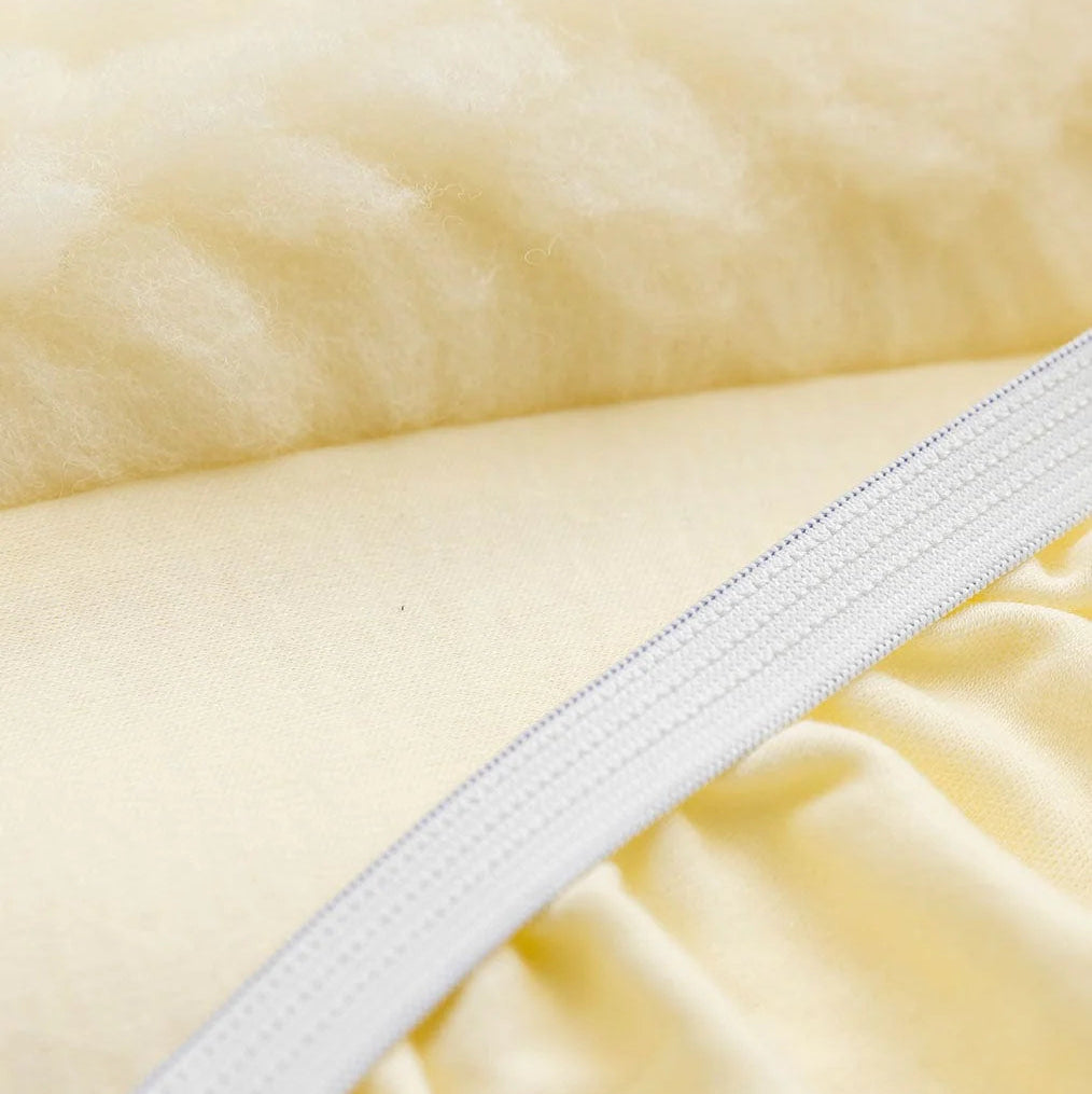 Close-up of a white zipper on beige fabric