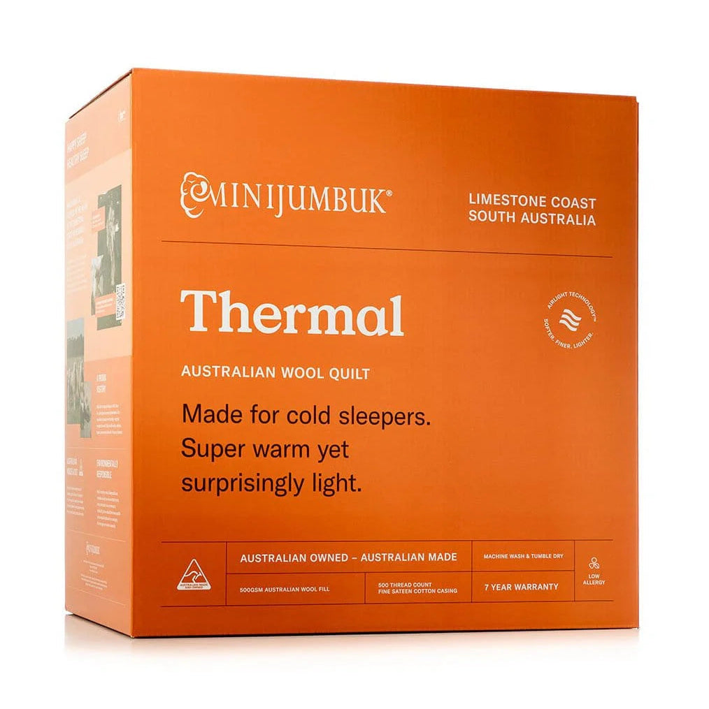 A bright orange product box for a Minijumbuk Thermal Australian Wool Quilt, photographed on a clean white background.