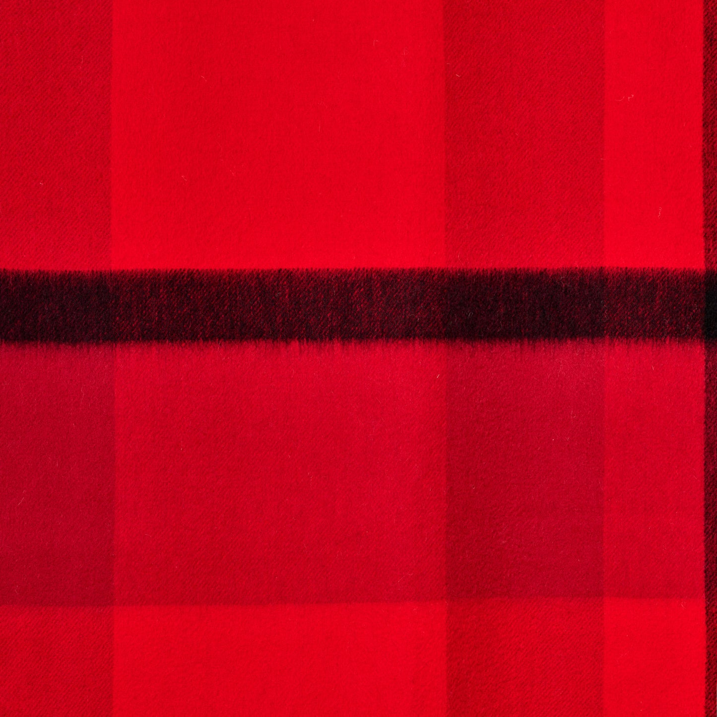 Flat lay of a plaid wool shawl showing its texture