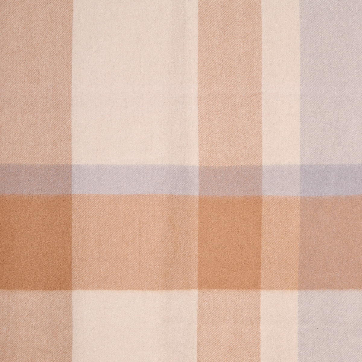 Close-up flat lay of a plaid merino wool shawl, showcasing its soft texture and plaid pattern