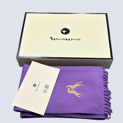 Purple scarf with gold embroidery and a matching card on a gray background, featuring the WooliWooli brand.