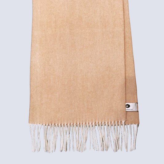 Beige scarf with fringes on a light gray background