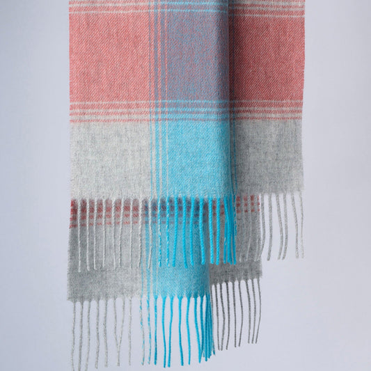 A plaid wool scarf with plaid in coral, blue, and gray colours, displayed neatly with fringes at the bottom.