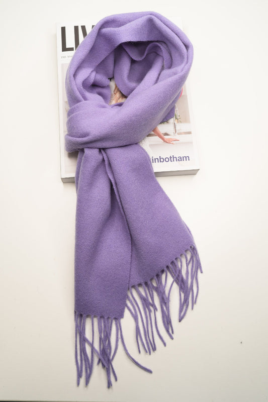 Purple scarf with tassels on a magazine