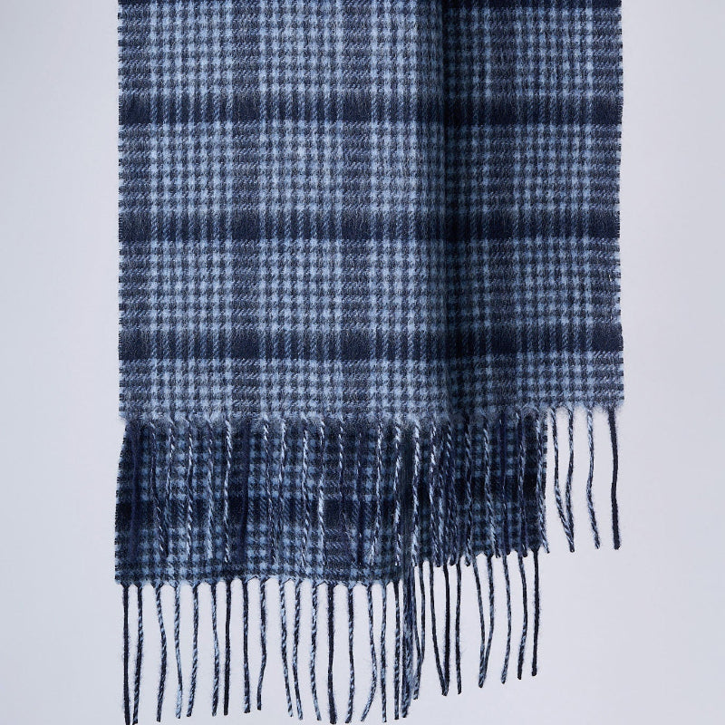 A pin check pattern merino wool scarf in navy and gray colors with fringes.