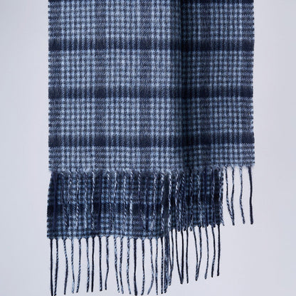 A pin check pattern merino wool scarf in navy and gray colors with fringes.