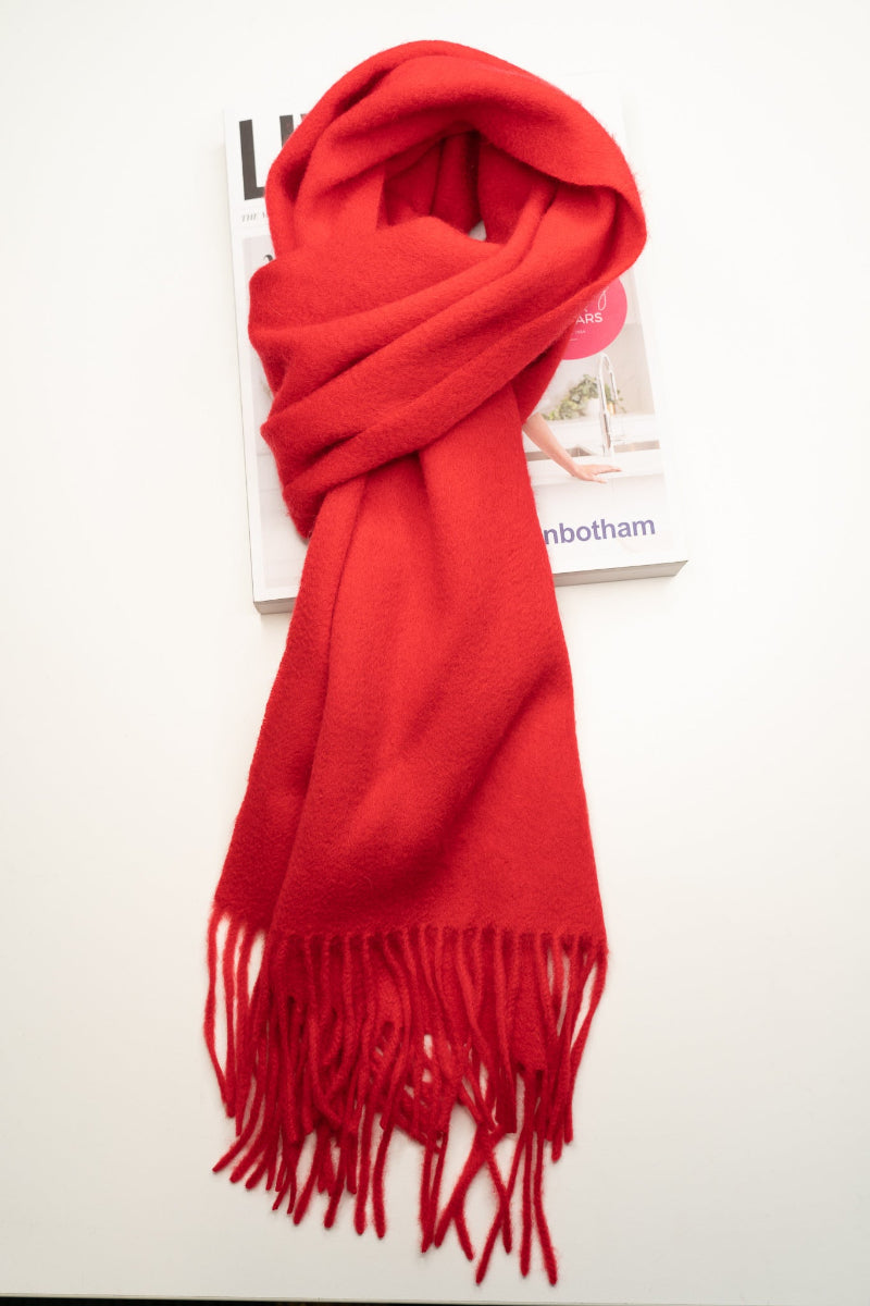 Red scarf with tassels on a white background
