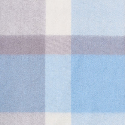 Close-up of a plaid wool fabric with brown, beige, and blue colours.