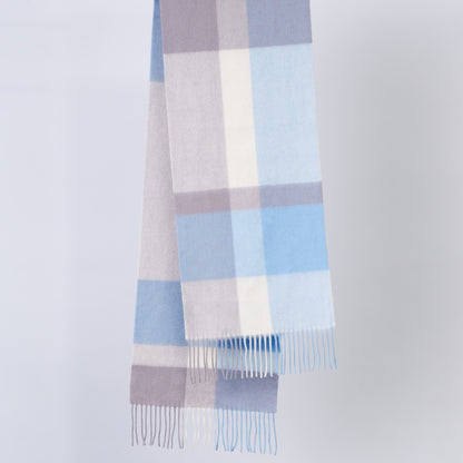 Plaid wool scarf with blue, gray, and white colours on a light gray background