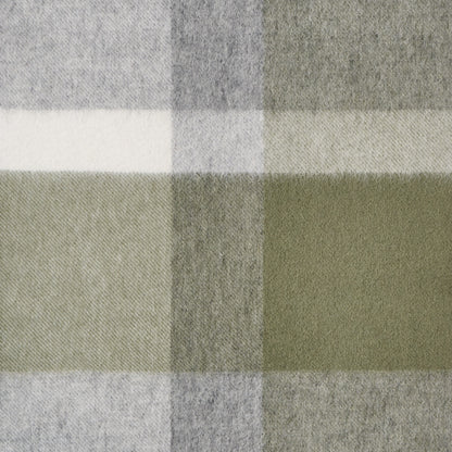 Close-up of a plaid wool fabric with green, grey, and white colours.