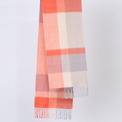 Plaid wool scarf with orange, pink, and gray colors on a light gray background