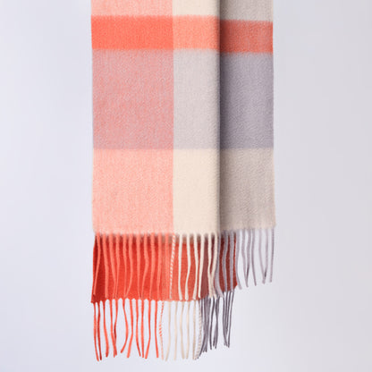 Plaid wool scarf with pink, orange, and gray colors on a light gray background