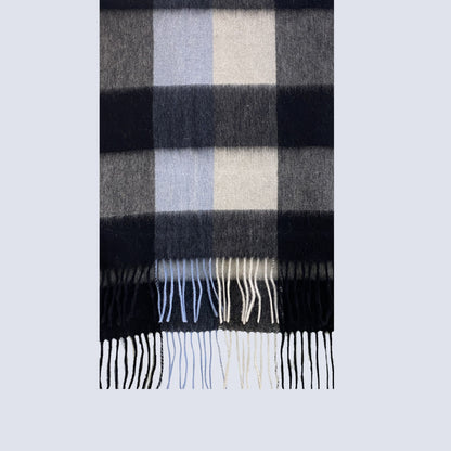 Plaid scarf with black, gray, and white colors on a light gray background