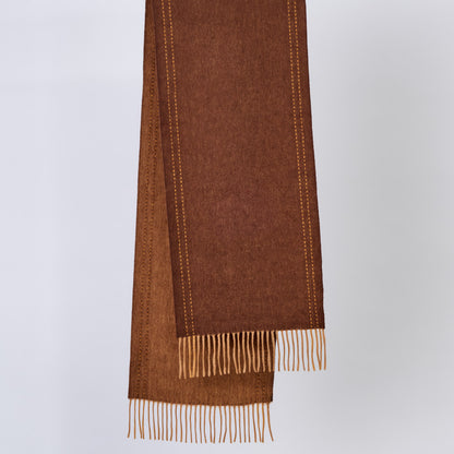 Brown wool scarf with fringe on a light gray background