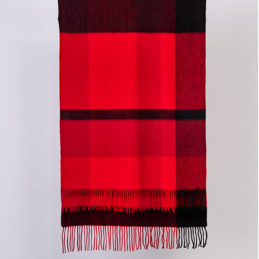Red and black checkered wool scarf with fringes on a white background
