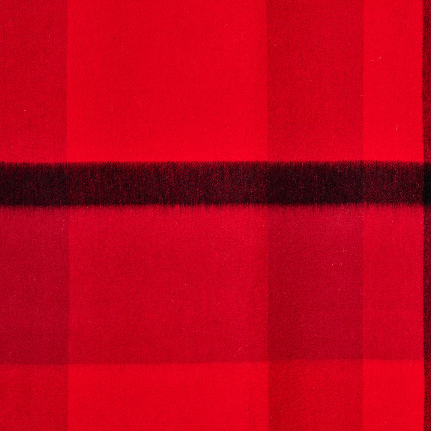 Flat lay of a plaid wool shawl showing its texture