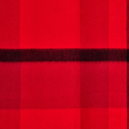 Flat lay of a plaid wool shawl showing its texture