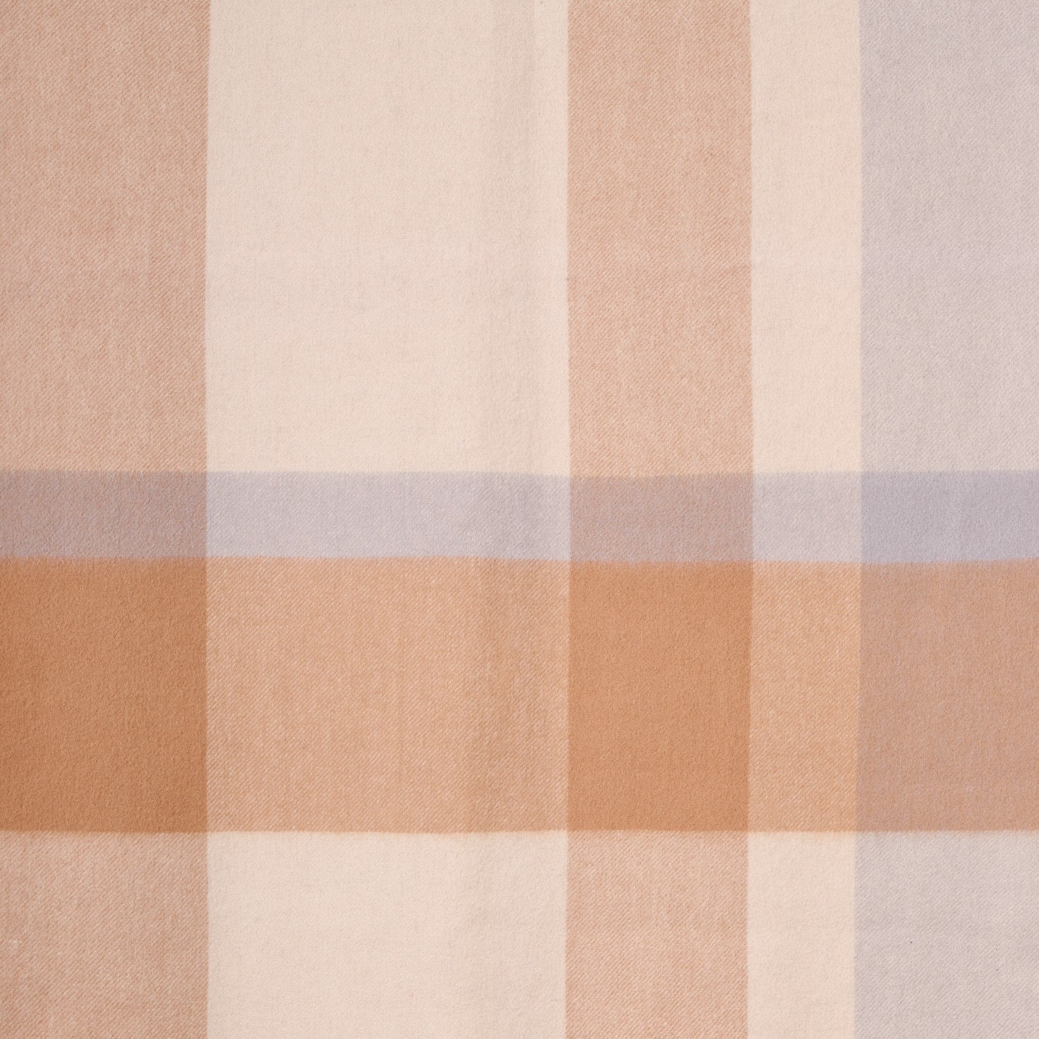 Close-up flat lay of a plaid merino wool shawl, showcasing its soft texture and plaid pattern