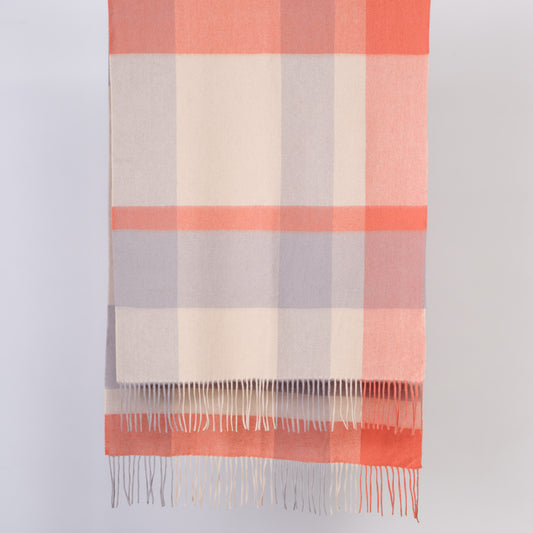 Plaid scarf with orange, beige, and light purple colours on a light gray background