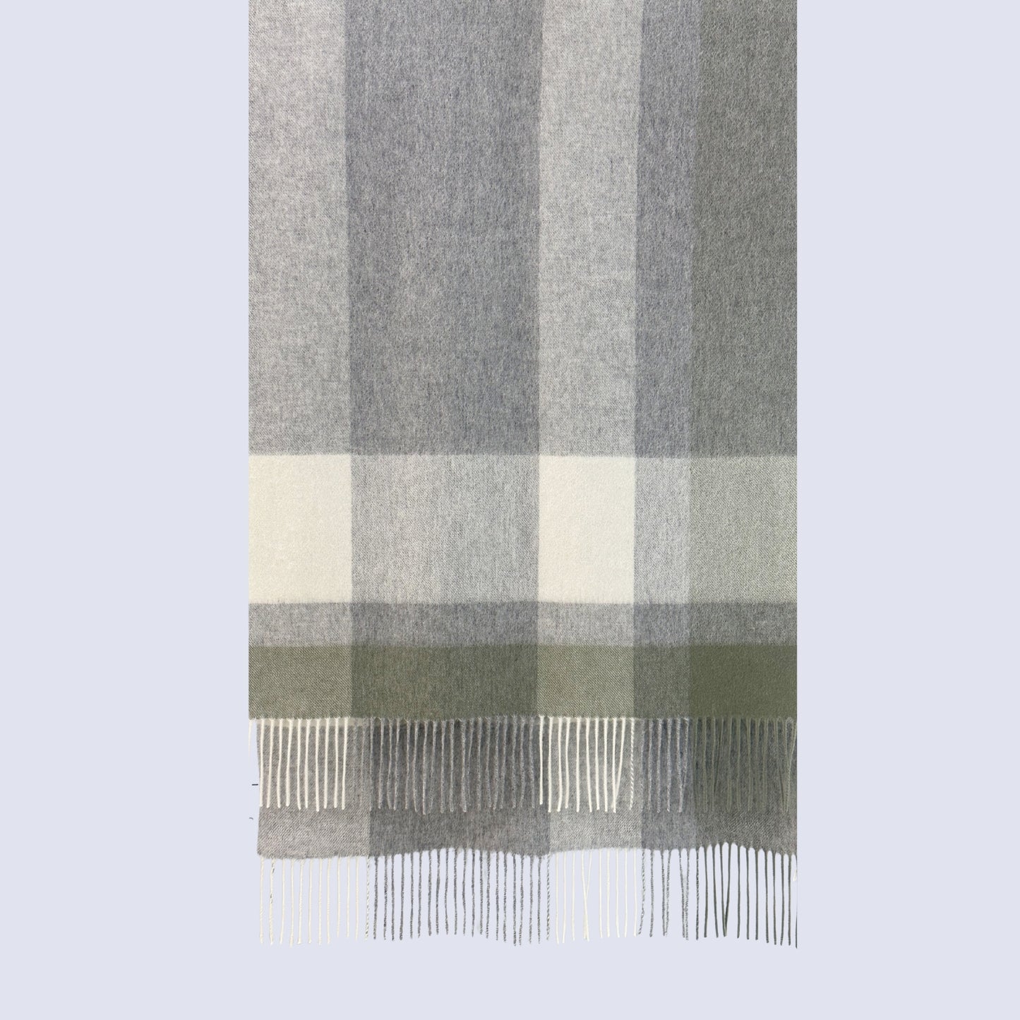 Plaid scarf with gray, green, and white colors on a light gray background