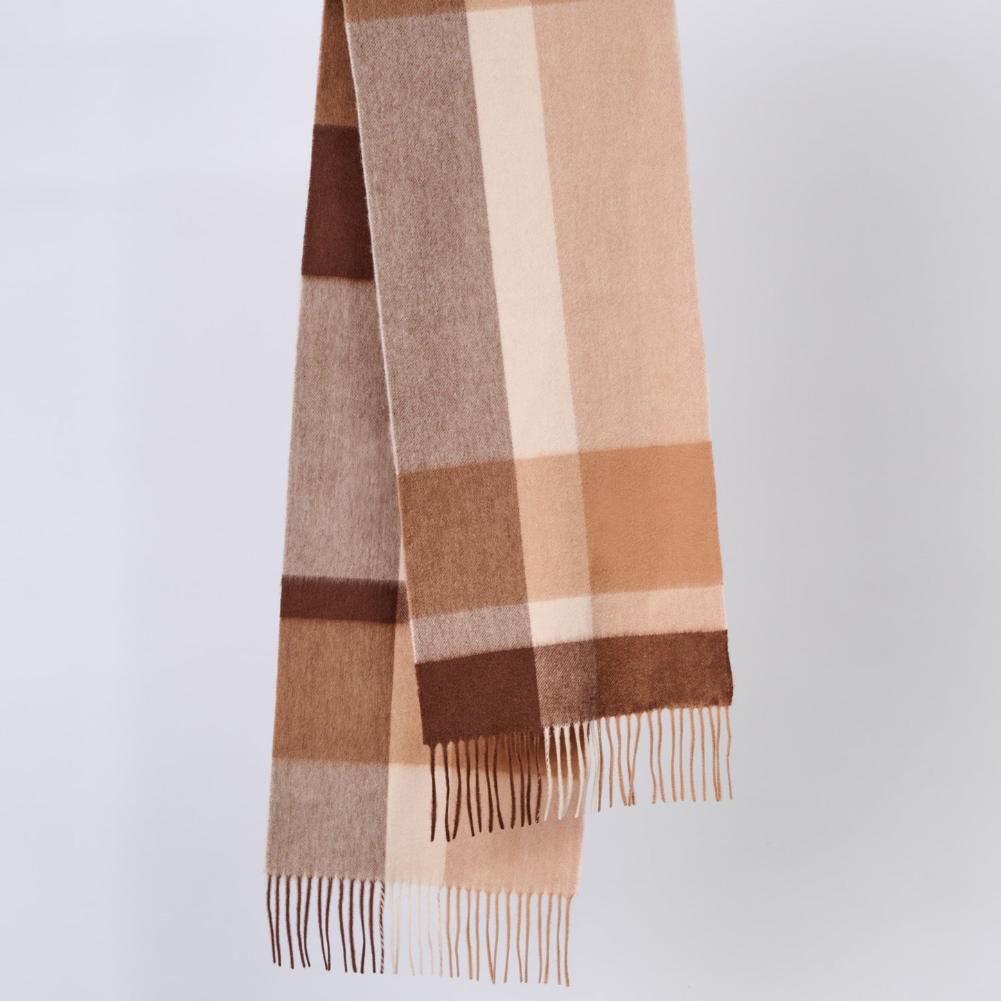 Plaid wool scarf with brown and beige colors on a light gray background