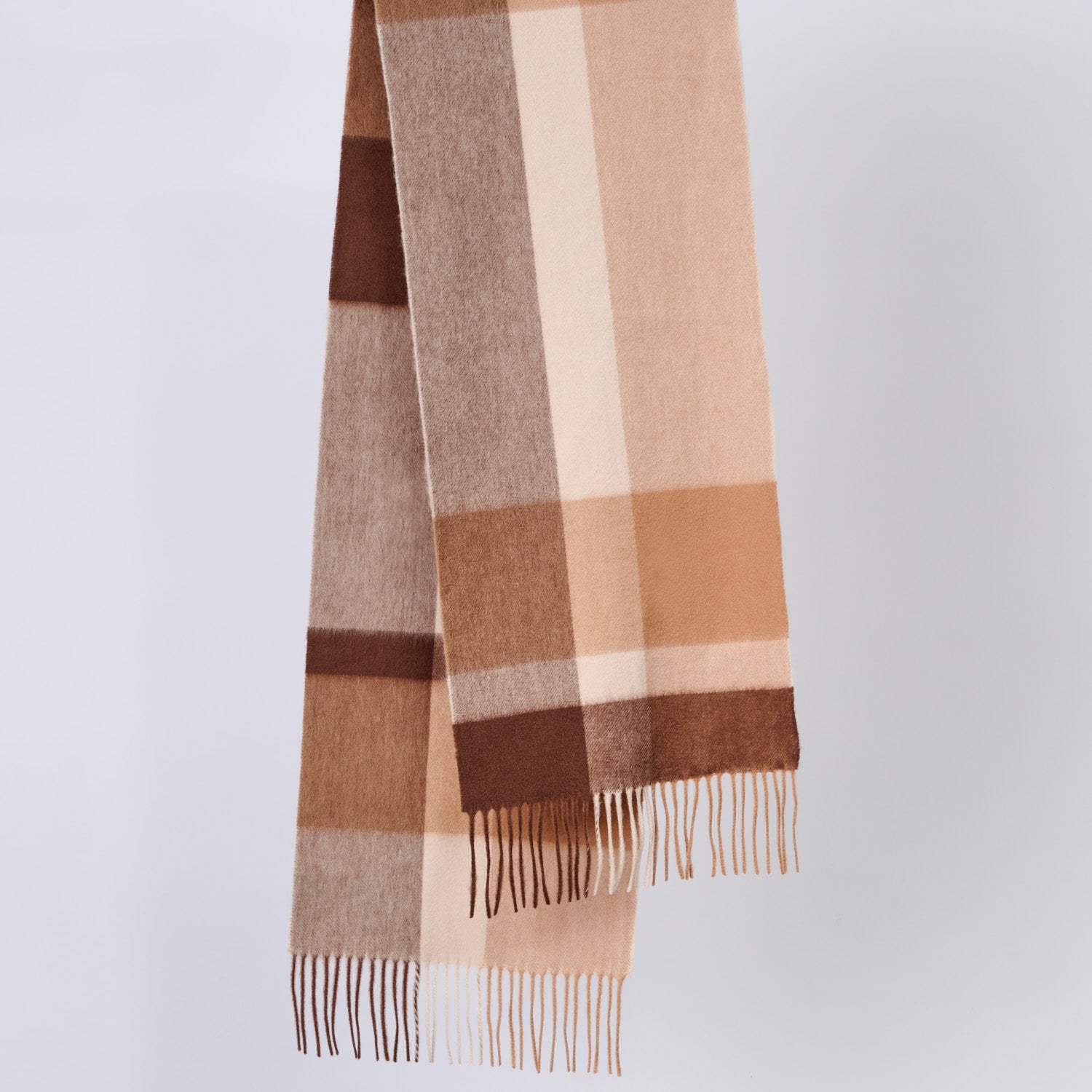 Plaid wool scarf with brown and beige colors on a light gray background