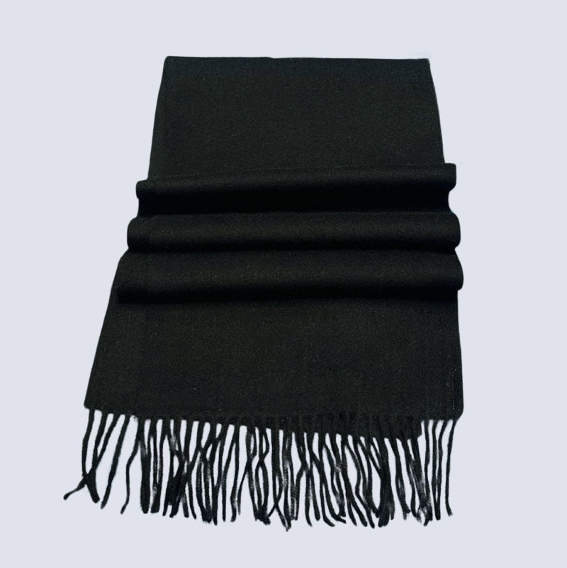 Black scarf with fringes on a light gray background