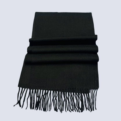 Black scarf with fringes on a light gray background