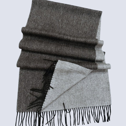 Black and Grey double-sided shawl with black fringe on a light gray background