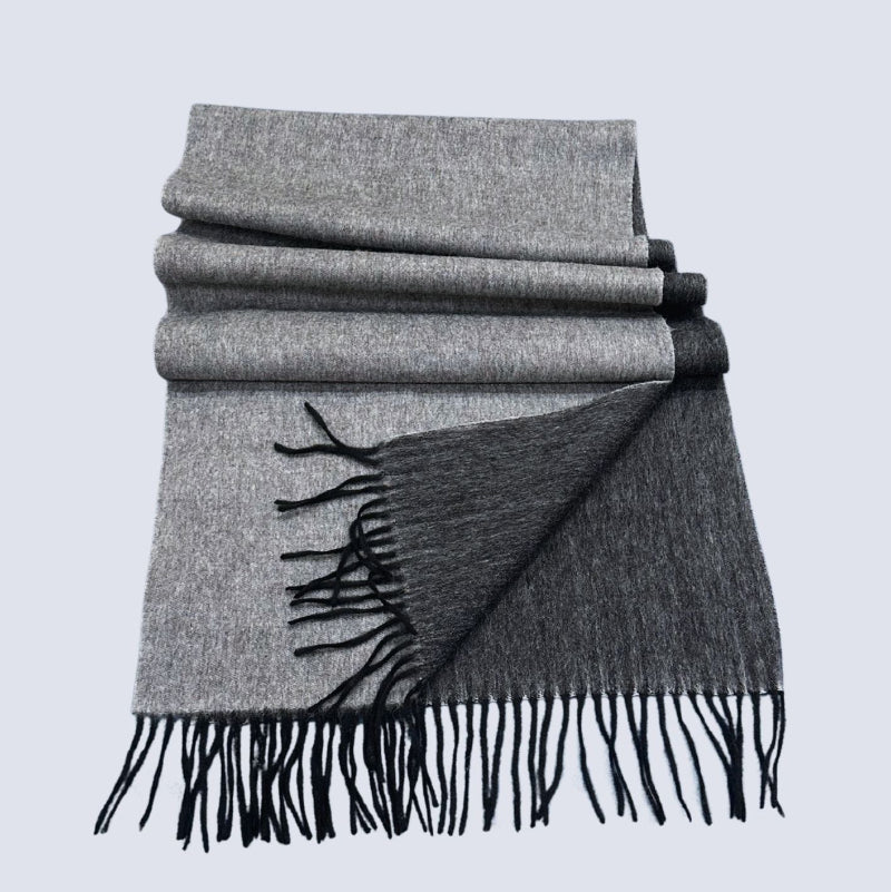 Black and Grey double-sided shawl with black fringe on a light gray background