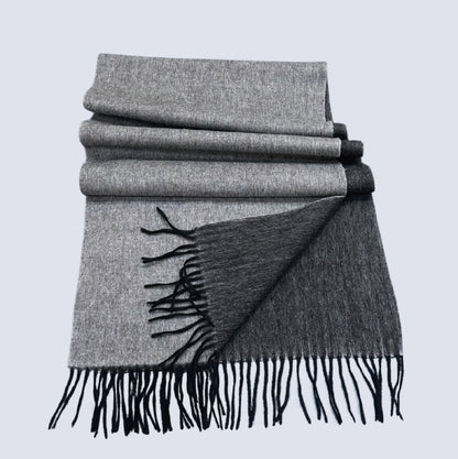Black and Grey double-sided shawl with black fringe on a light gray background