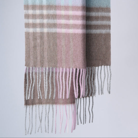 A striped merino wool scarf in shades of pink, blue, and brown with fringes, laid flat against a white background.
