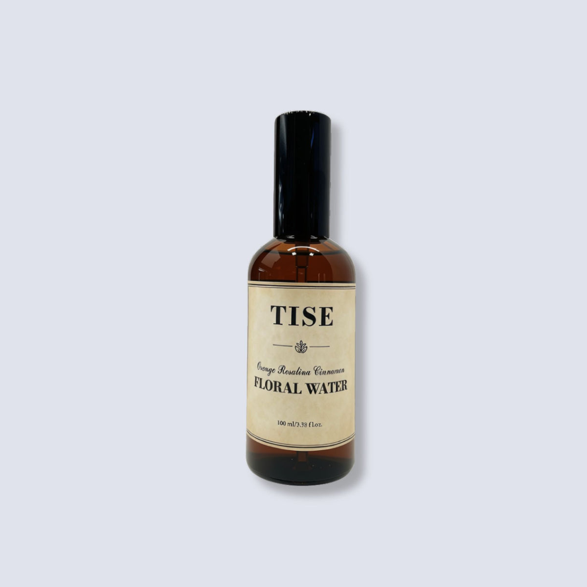 A 100ml amber glass bottle of TISE Orange Blossom Variegated Floral Water with a black cap and cream label, centered on a light gray background.