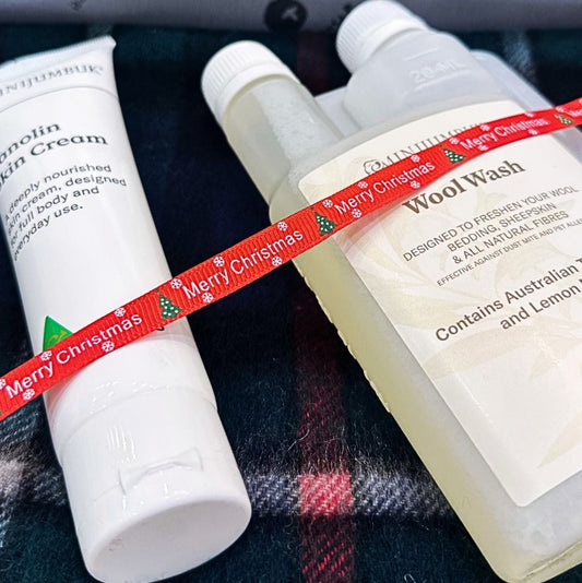 Two bottles with labels on a plaid fabric background