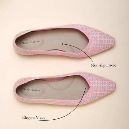 Pink pointed-toe shoes with non-slip insole and elegant V-cut design on a beige background.
