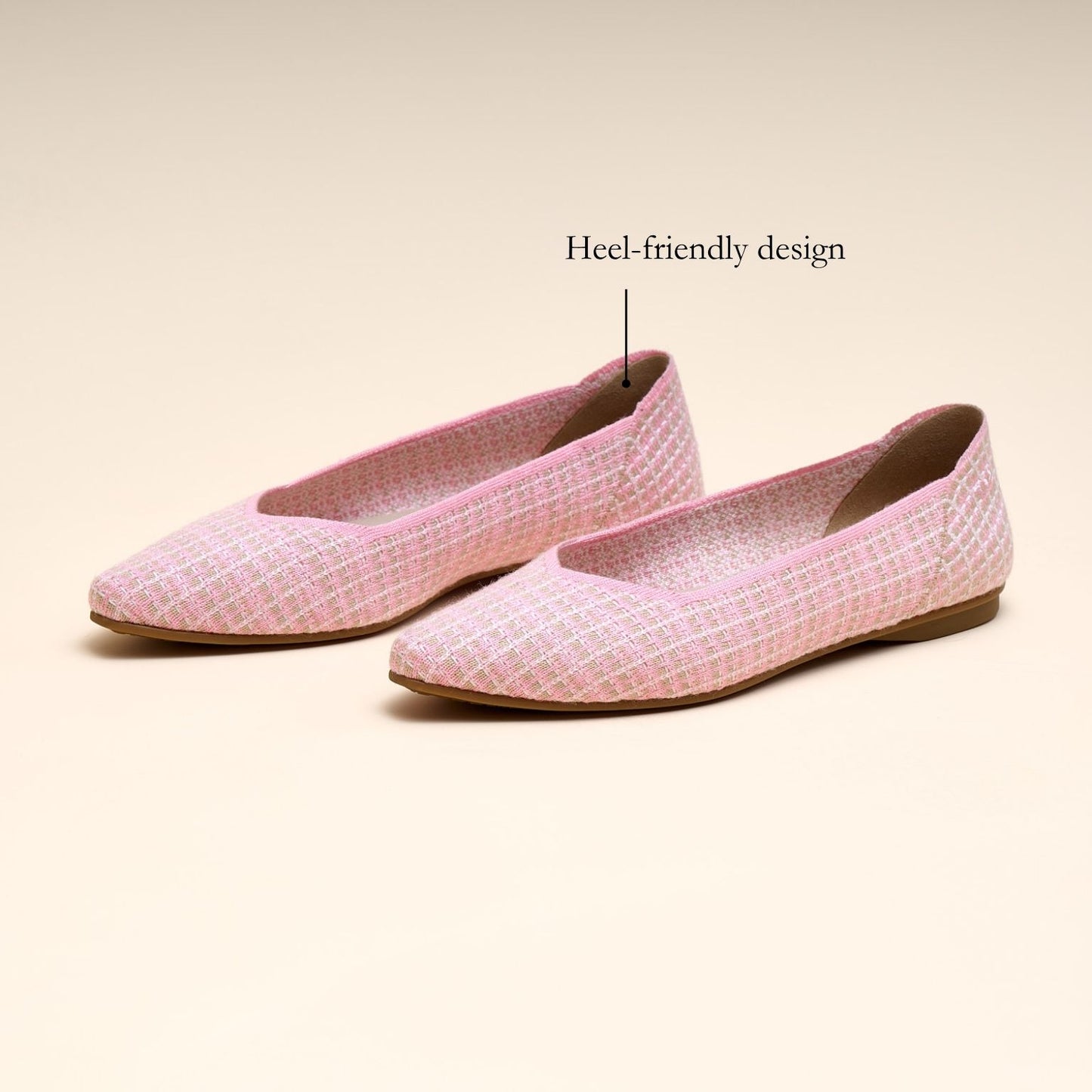 Pink flat shoes with a textured pattern on a beige background