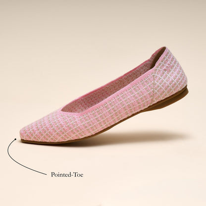 Pink flat shoe with pointed-toe feature on a beige background