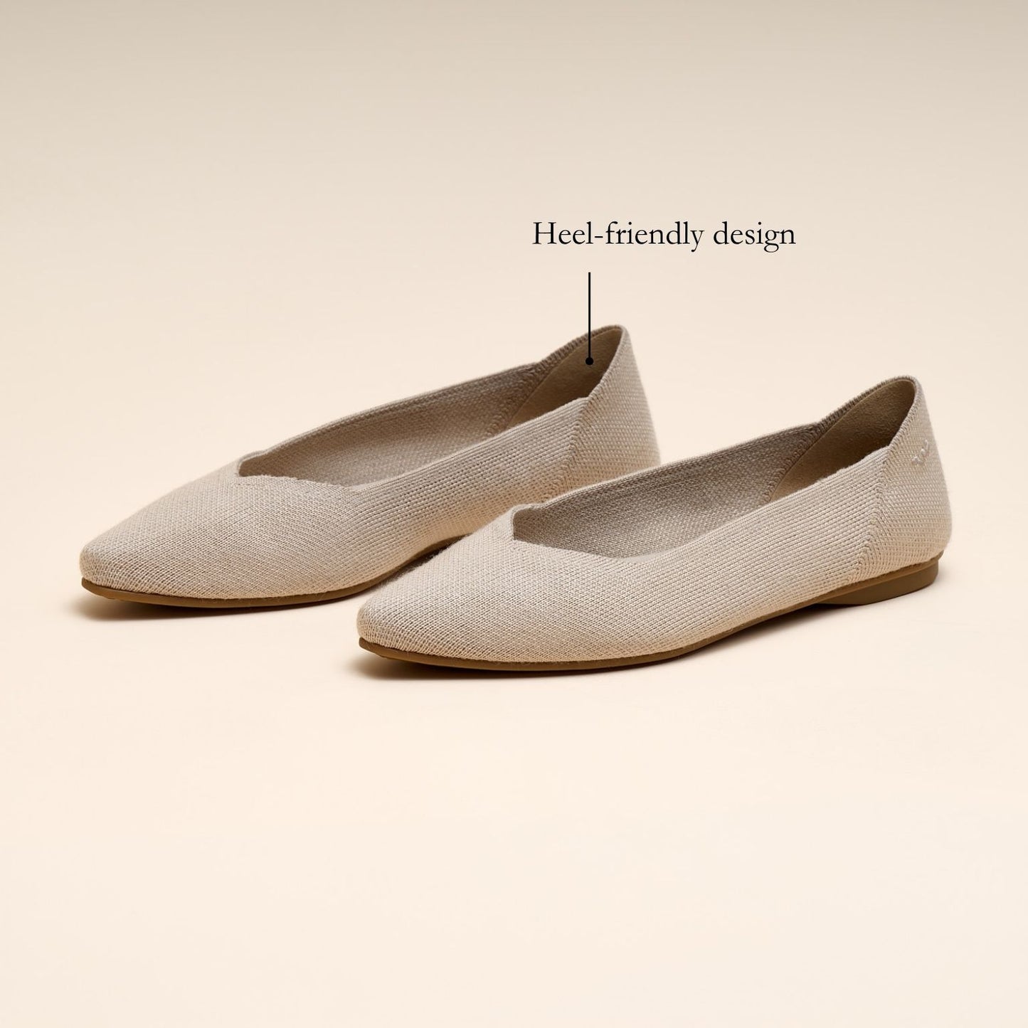 Pair of beige flat shoes on a beige background with text 'Heel-friendly design'.