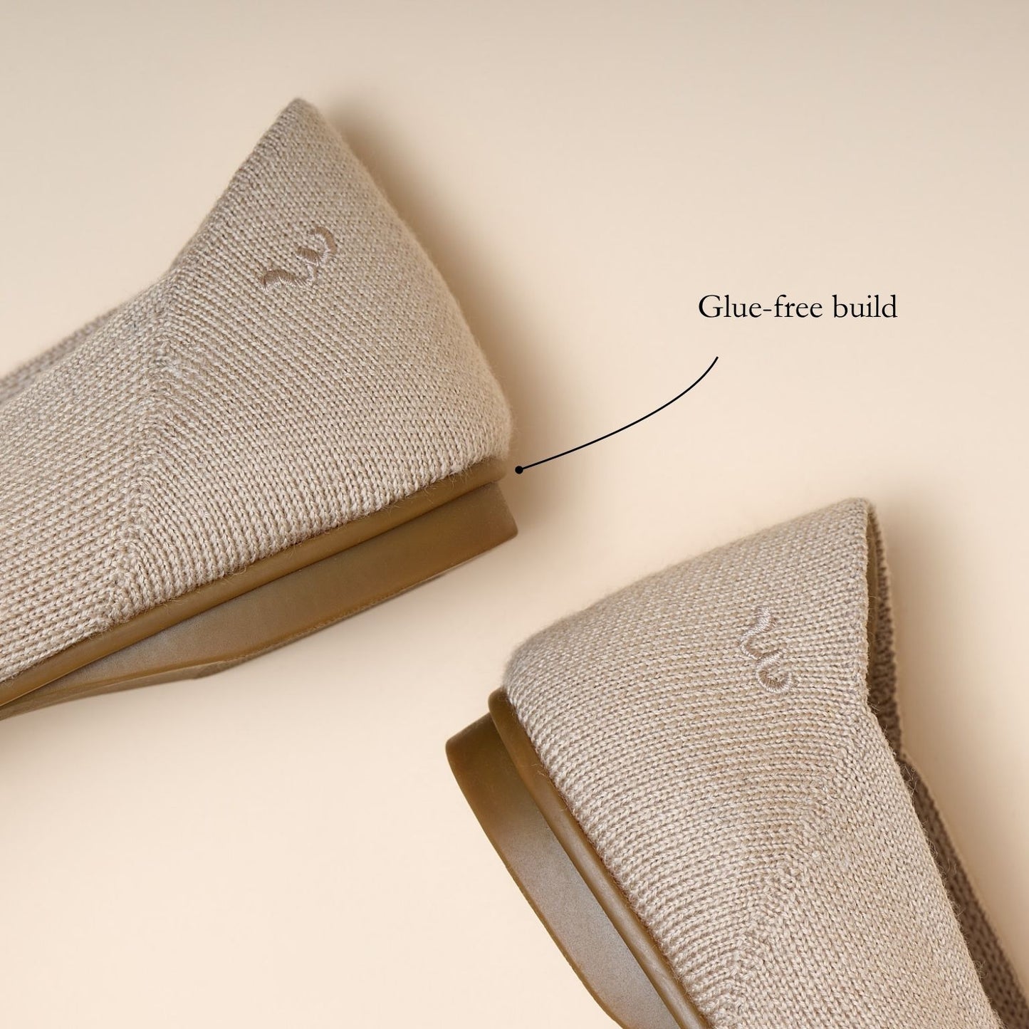 Two gray socks with a glue-free build label on a beige background