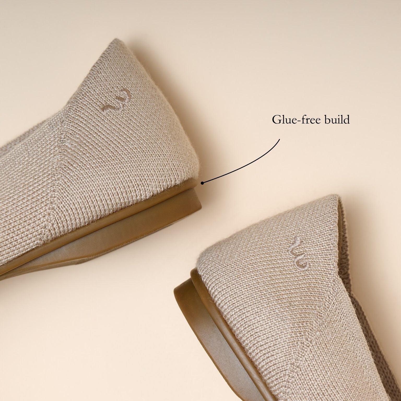 Two gray socks with a glue-free build label on a beige background