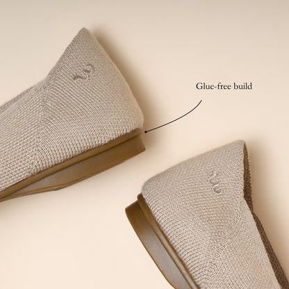 Two gray socks with a glue-free build label on a beige background
