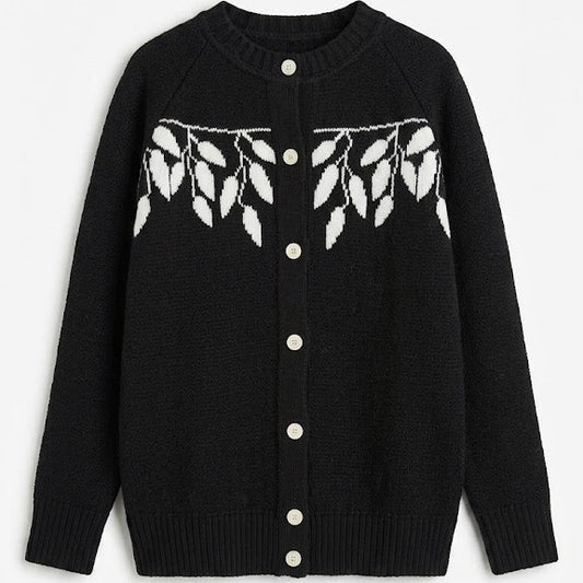 Black cardigan with white button details and leaf pattern on a white background